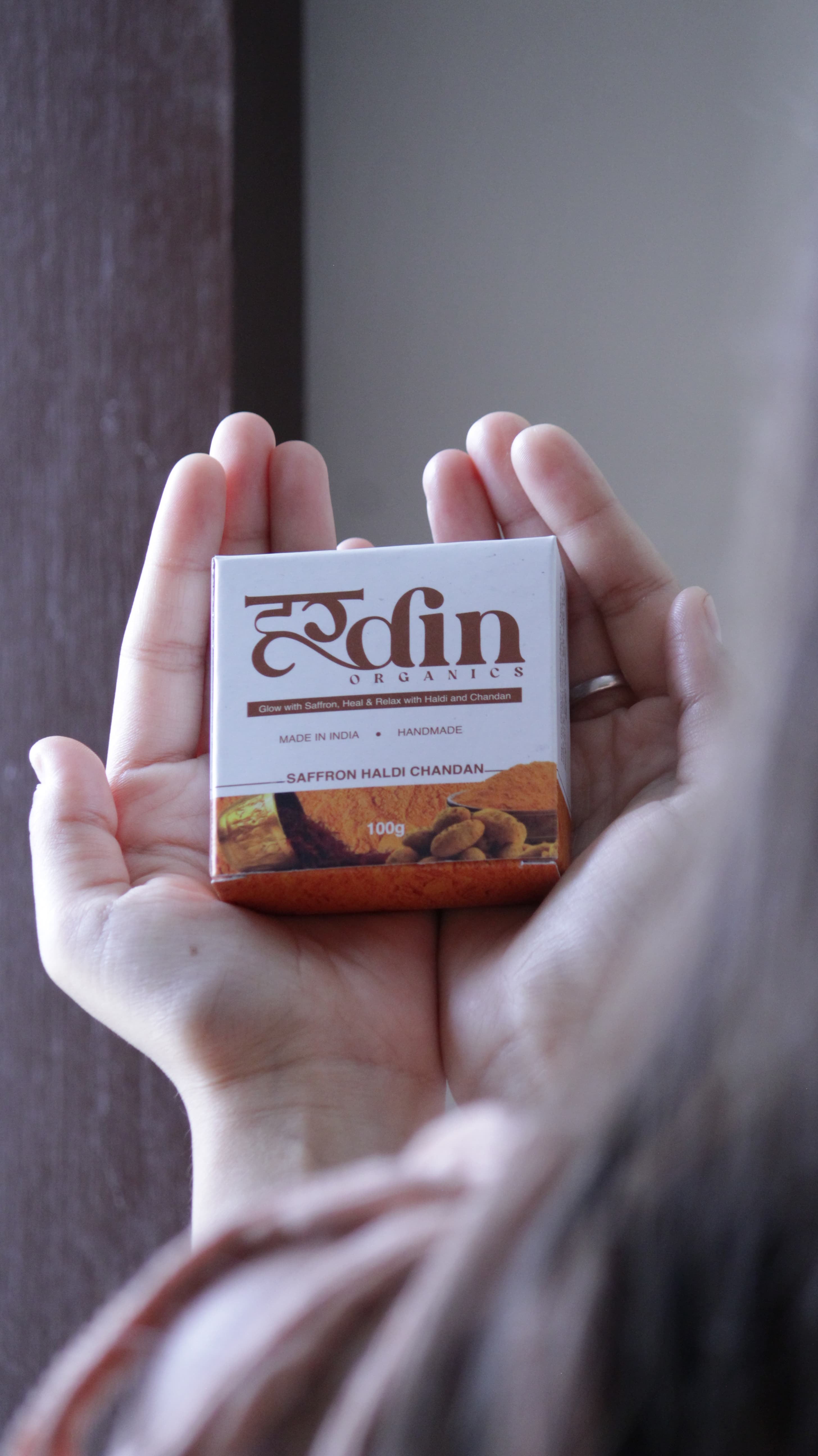 Hardin Organics Saffron Haldi Chandan soap held by founder Dhruv